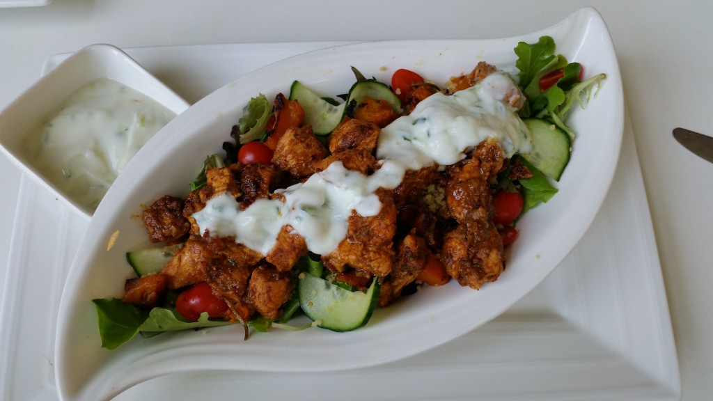 Moroccan chicken salad, nicely presented on elegant white crockery. 