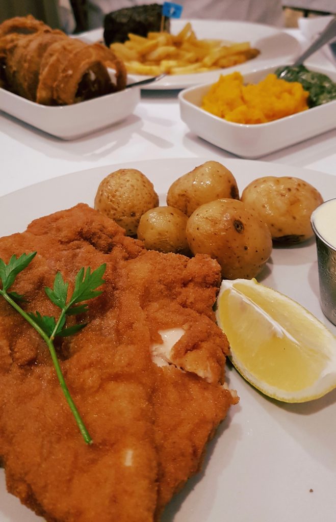 Crumbed chicken schnitzel with Frank's peppered fillet in the background along with his rather odd onions rings. 